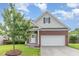 Charming brick home with a two-car garage, manicured lawn, and inviting entrance at 543 Callandale Ln, Durham, NC 27703