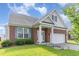 Beautiful brick house with manicured lawn, a front porch, and a two-car garage at 543 Callandale Ln, Durham, NC 27703