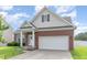 A well-maintained home features brick accents, a two-car garage, and an attractive entryway at 543 Callandale Ln, Durham, NC 27703
