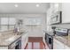 Bright kitchen featuring granite countertops, white cabinetry, hardwood floors, and stainless appliances at 543 Callandale Ln, Durham, NC 27703