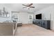 Spacious living room with neutral carpeting, ceiling fan, and a media center at 543 Callandale Ln, Durham, NC 27703