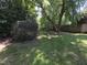 Backyard with mature trees and grass providing a serene and private outdoor space at 5893 Shady Grove Cir, Raleigh, NC 27609
