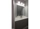 Bathroom with modern vanity, stylish lighting, and a large mirror at 5893 Shady Grove Cir, Raleigh, NC 27609