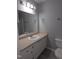 Bathroom with white vanity, ample countertop space, updated fixtures, and large mirror at 5893 Shady Grove Cir, Raleigh, NC 27609