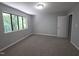 Spacious bedroom featuring a large window and plush carpeting for a comfortable living space at 5893 Shady Grove Cir, Raleigh, NC 27609
