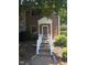 Inviting entrance to a red brick townhome with well-maintained landscaping at 5893 Shady Grove Cir, Raleigh, NC 27609
