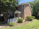 Charming red brick townhome with a well-manicured lawn and inviting entryway at 5893 Shady Grove Cir, Raleigh, NC 27609