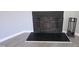 Close up view of the black fireplace with safety screen, tools, and slate hearth at 5893 Shady Grove Cir, Raleigh, NC 27609