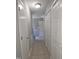 Clean hallway with tiled floors and multiple doors, creating easy navigation within the home at 5893 Shady Grove Cir, Raleigh, NC 27609