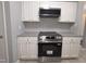 Well-lit kitchen with stainless steel appliances and white cabinets at 5893 Shady Grove Cir, Raleigh, NC 27609