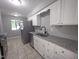 Bright kitchen with stainless steel appliances, granite countertops and white cabinets at 5893 Shady Grove Cir, Raleigh, NC 27609