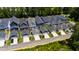 Aerial view of homes in community with manicured lawns, driveways, garages and mature trees at 690 Great Ridge Pkwy, Chapel Hill, NC 27516