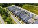 Aerial view of houses with manicured lawns, driveways, and garages in a desirable community at 690 Great Ridge Pkwy, Chapel Hill, NC 27516