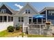 Backyard with deck, grill, umbrella-covered dining table, white fence, lawn, and partial view of house at 690 Great Ridge Pkwy, Chapel Hill, NC 27516