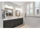 Bathroom featuring double sink vanity with gray cabinets, white countertops, and tiled floors at 690 Great Ridge Pkwy, Chapel Hill, NC 27516
