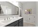 Bathroom with dual sinks, granite vanity top, and mirror at 690 Great Ridge Pkwy, Chapel Hill, NC 27516