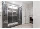 Modern bathroom with glass enclosed shower with bench and gray tile surround at 690 Great Ridge Pkwy, Chapel Hill, NC 27516