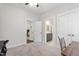 Well-lit bedroom with doorway to attached bathroom, desk, and plush carpet flooring at 690 Great Ridge Pkwy, Chapel Hill, NC 27516