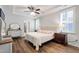Spacious main bedroom with tray ceiling, ceiling fan, wood floors, and ensuite bathroom at 690 Great Ridge Pkwy, Chapel Hill, NC 27516
