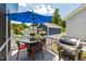 Outdoor deck featuring a dining table with an umbrella, grill, and beautiful plantings perfect for entertaining at 690 Great Ridge Pkwy, Chapel Hill, NC 27516