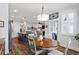 Open-concept dining room with modern lighting, hardwood floors, and easy access to the kitchen and screened in porch at 690 Great Ridge Pkwy, Chapel Hill, NC 27516