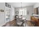 Bright dining room with wood floors, contemporary light fixture and classic furniture at 690 Great Ridge Pkwy, Chapel Hill, NC 27516