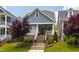 Charming home with brick foundation, landscaped yard, and welcoming staircase leading to the front porch at 690 Great Ridge Pkwy, Chapel Hill, NC 27516