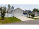 Detached one-car garage with white door and driveway flanked by green grass, fence, and other garages at 690 Great Ridge Pkwy, Chapel Hill, NC 27516