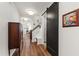 Inviting hallway with hardwood floors, modern lighting, and convenient access to stairs and storage at 690 Great Ridge Pkwy, Chapel Hill, NC 27516