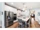 Modern kitchen featuring stainless steel appliances, a center island with seating, and bright white cabinets at 690 Great Ridge Pkwy, Chapel Hill, NC 27516