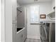 Well-organized laundry room with washer, dryer, utility sink, and storage cabinets at 690 Great Ridge Pkwy, Chapel Hill, NC 27516