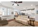 Comfortable living room featuring a ceiling fan, hardwood floors, and an open-concept design flowing into the kitchen at 690 Great Ridge Pkwy, Chapel Hill, NC 27516