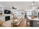 Open-concept living area with fireplace, built-ins, and seamless connection to the modern kitchen at 690 Great Ridge Pkwy, Chapel Hill, NC 27516