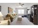 Bright living room with comfortable seating, TV, and natural light from the window at 690 Great Ridge Pkwy, Chapel Hill, NC 27516