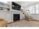 Cozy living room featuring a fireplace with built-in shelves, comfortable seating, and a neutral color palette at 690 Great Ridge Pkwy, Chapel Hill, NC 27516