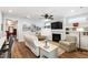 Inviting living room with fireplace, mounted TV, stylish furnishings, and a glimpse of the red entry door at 690 Great Ridge Pkwy, Chapel Hill, NC 27516