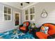 Charming covered patio featuring comfortable seating, stylish decor, and a ceiling fan for relaxing outdoor living at 690 Great Ridge Pkwy, Chapel Hill, NC 27516