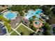 An aerial view of the community pool area with a slide, playground, and plenty of seating at 690 Great Ridge Pkwy, Chapel Hill, NC 27516