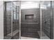 Modern shower with glass doors, bench seating, grab bar, and shampoo niche at 690 Great Ridge Pkwy, Chapel Hill, NC 27516