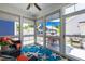 Enclosed sunroom with wicker furniture, ceiling fan, and view of the backyard at 690 Great Ridge Pkwy, Chapel Hill, NC 27516