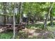 Secluded backyard featuring a picnic table, a rustic playset, and mature shade trees at 767 Omaha Dr, Broadway, NC 27505