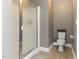 Neutral bathroom featuring a shower with a frosted glass door and a toilet at 767 Omaha Dr, Broadway, NC 27505