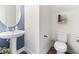 Stylish half-bathroom with pedestal sink, round mirror, and neutral paint at 767 Omaha Dr, Broadway, NC 27505