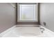 Soaking tub under a frosted glass window at 767 Omaha Dr, Broadway, NC 27505