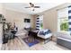 Bright bedroom with wood-look floors, a ceiling fan, and a window view at 767 Omaha Dr, Broadway, NC 27505