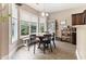 Bright dining area featuring a round table, bench seating, and large windows at 767 Omaha Dr, Broadway, NC 27505