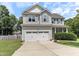 Charming two-story home with a two-car garage, complemented by well-maintained landscaping and great curb appeal at 767 Omaha Dr, Broadway, NC 27505