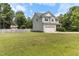 Well-maintained two-story home with an attached two-car garage and a spacious lawn surrounded by mature trees at 767 Omaha Dr, Broadway, NC 27505