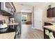 Kitchen with stainless appliances, wood-look flooring, and granite countertops at 767 Omaha Dr, Broadway, NC 27505