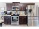 Kitchen featuring stainless steel appliances, and dark wood cabinets at 767 Omaha Dr, Broadway, NC 27505